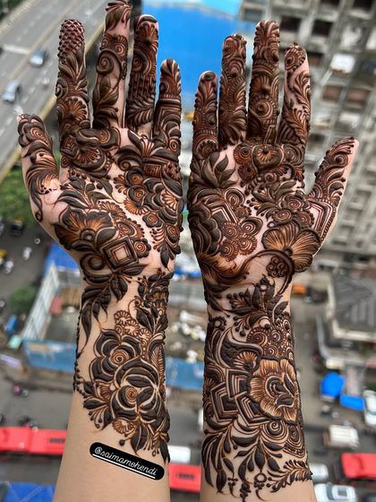 A stunning shot of a full-arm mehendi against a city skyline, blending tradition with a modern, urban backdrop.