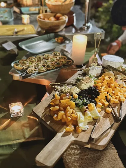 I believe ambiance is a key ingredient. This shot captures a beautiful cheese and fruit board set amidst the soft glow of candlelight, creating an intimate and luxurious vibe that elevates the entire dining experience.