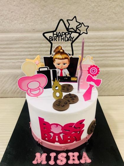 A fun Boss Baby cake for the little one who rules the house. This design is perfect for an 8th birthday, featuring a girl boss theme with a pacifier and cookies.