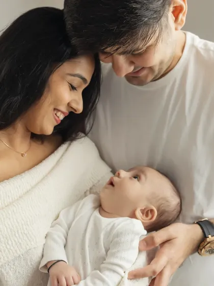 A candid moment of pure adoration as parents gaze at their newborn. These unposed shots are often the most precious.