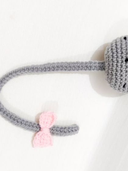 An adorable cat bookmark for the book lovers. This little grey kitty with a pink bow will happily save your page for you.