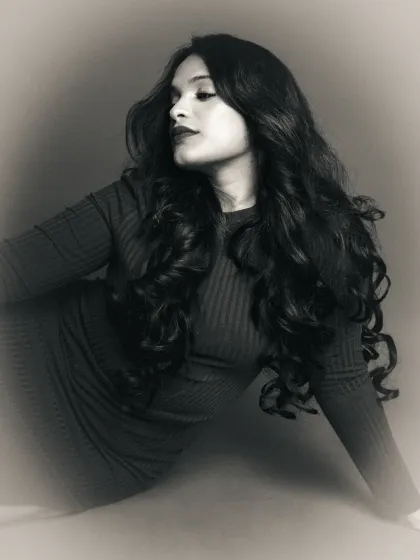 A moody black and white edit of a profile portrait. The soft focus and grain create an atmospheric and introspective feel, transforming the original color shot.