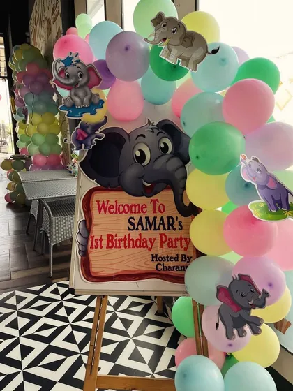 A warm welcome for Samar's first birthday party. This custom elephant-themed welcome sign, surrounded by a colorful balloon arrangement, set a cheerful tone right from the entrance.