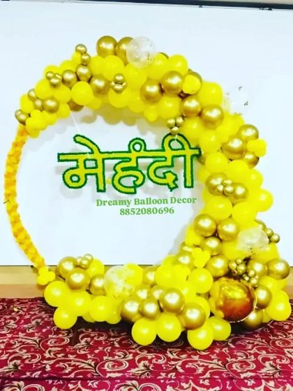 A beautiful 'Mehendi' backdrop for your pre-wedding ceremony. This circular balloon arch is made with yellow and gold balloons, with a custom 'Mehendi' sign in Hindi at the center.