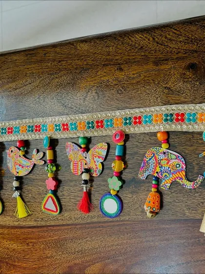 A full view of the 'Bageecha Toran', showing how all the different elements like tassels, beads, and mirrors come together.