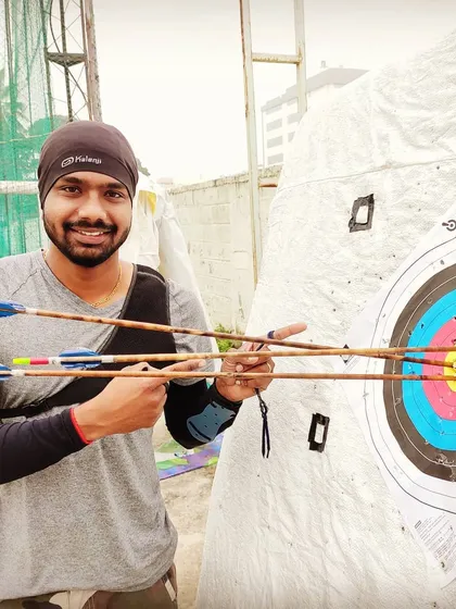 The result of dedication. Here I am with a tight grouping of arrows right in the bullseye. We teach that excellence in archery comes from consistent, hard work, and we lead by example in every training session.