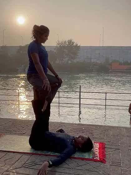 A variation of the throne pose, showing stability and balance from both partners.