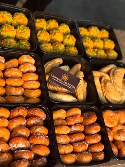 All our festival orders are packed hygienically in convenient trays. This image shows a bulk order of our Holi sweets, showcasing the care I take in preparing and delivering your food.
