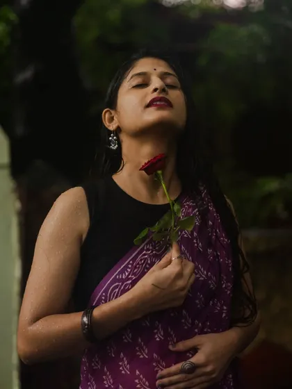 An expressive portrait capturing a feeling of serenity. With her eyes closed and holding a red rose, the model seems lost in a peaceful moment, showcasing the emotional depth I aim for in my work.