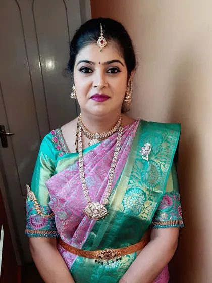 A portrait shot showing the harmonious blend of makeup, jewelry, and attire for her special housewarming day.