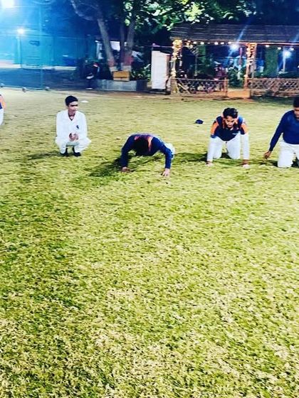 A group of players engaged in a floor-based stretching routine. We emphasize cooling down properly to aid recovery and prevent muscle soreness.