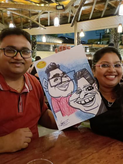 A couple with their caricature at Mountain High. It's a fun date night activity.