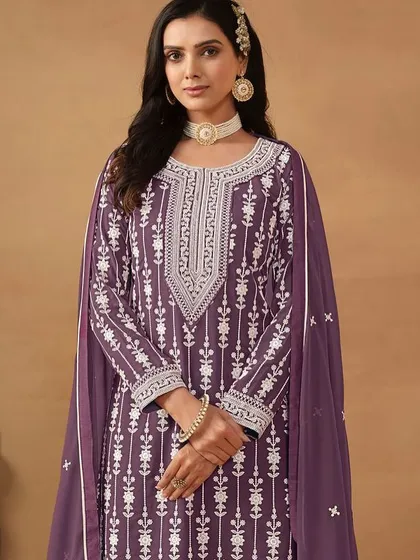 A regal purple salwar kameez with intricate white thread embroidery. The georgette fabric gives it a beautiful flow, making you feel like a queen.