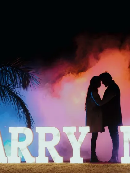 A dramatic and romantic silhouette against a "Marry Me" marquee sign. I love playing with creative props and lighting to create unique, statement shots for your pre-wedding album.