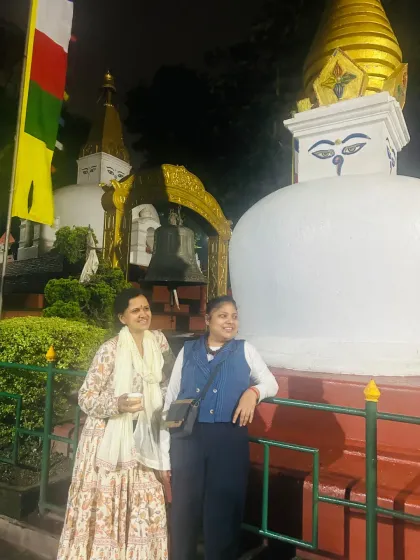 Two travelers from our group sharing a quiet moment at the stupa. The atmosphere here is one of gentle contemplation and shared reverence.