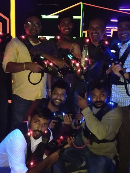 This group is all smiles, ready to enter the laser tag arena and battle it out.