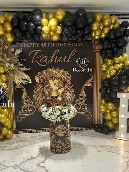 We love a bold and regal theme. For this 40th birthday, we designed a powerful black and gold lion-themed backdrop, complete with a stunning balloon arch and custom floral arrangements, creating a truly majestic photo-op.