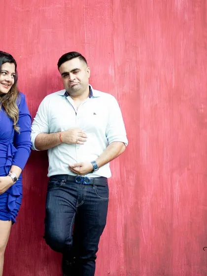 I love it when couples bring their sense of humor to a shoot. This playful "baby bump vs. beer bump" pose against a vibrant wall shows that maternity photos can be fun and full of personality. My sessions are all about capturing who you are as a couple.
