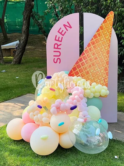 We scream for ice cream! This personalized 'Sureen' ice cream cone backdrop was the star of the party. The cone is a custom prop, and the 'ice cream' is a cascade of pastel balloons with sprinkle details.