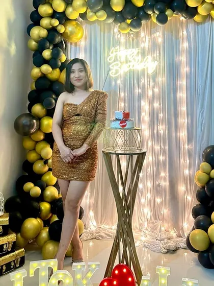 Your birthday should be all about you, shining bright. I designed this chic and modern party backdrop with a black and gold balloon arrangement, a shimmer wall, and a custom neon sign for a glamorous home celebration.
