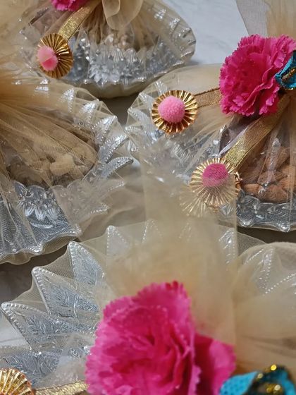 I was honored to create these special favors for a Jain Diksha ceremony. The dry fruits are packed in silver bowls and wrapped in delicate net with floral decorations, embracing the sacredness of the occasion.