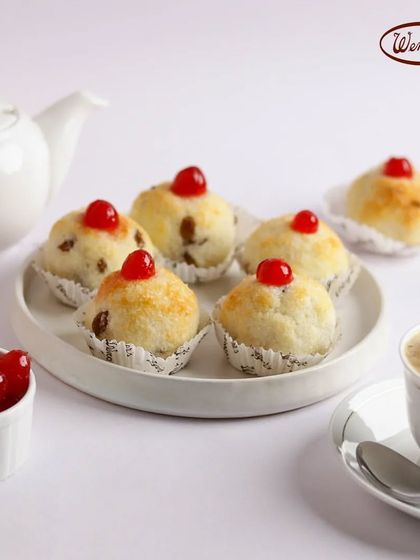 Our classic Coconut Macaroons, topped with a cherry. These chewy, sweet mounds of coconut are a nostalgic treat that has been on our menu for years.