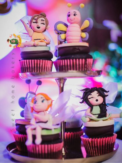 A display of more fairy and butterfly toppers, showcasing the variety and detail in the dessert set.