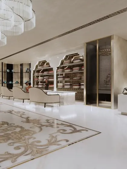 This perspective shows the relationship between the reception desk, the main retail floor, and the staircase. The consistent use of white, gold, and intricate patterns creates a cohesive and opulent interior design for the bridal store.