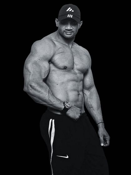 No nonsense, just results. A classic bodybuilding pose showing the muscle mass and symmetry that comes from consistent training.