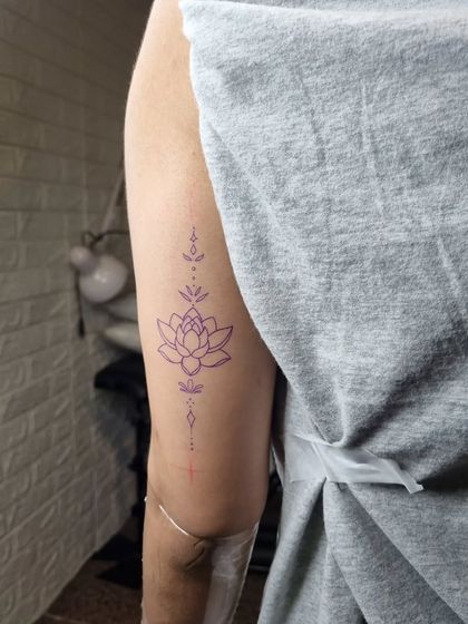 This ornamental lotus tattoo demonstrates clean, delicate line work. The fine line tattoo course module focuses on achieving this level of precision for elegant and minimalist designs.