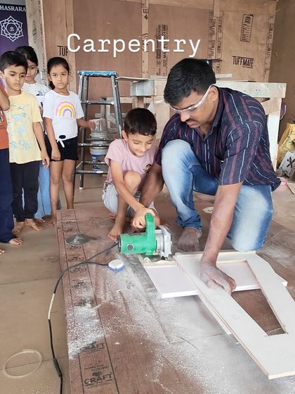 A carpentry session during our summer camp. Under careful supervision, a child learns to use tools, understanding the principles of geometry and construction.