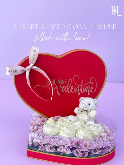 A heart-shaped floral hamper is the quintessential Valentine's gift. This one is filled with delicate flowers and a cute teddy bear, with "Be Mine Valentine" scripted on the box.