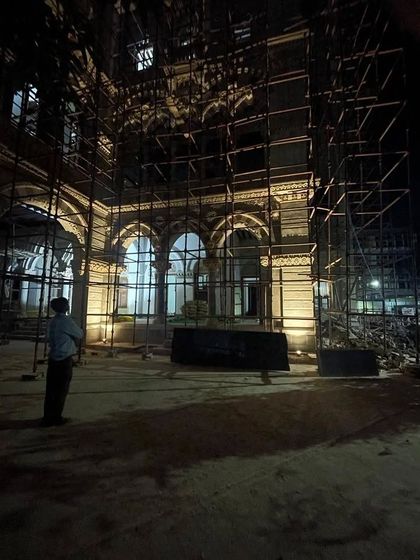 The first lighting test at night. Even with the scaffolding, you can see how the warm light begins to bring out the depth and texture of the archways and columns, transforming the flat surface into a three-dimensional spectacle.