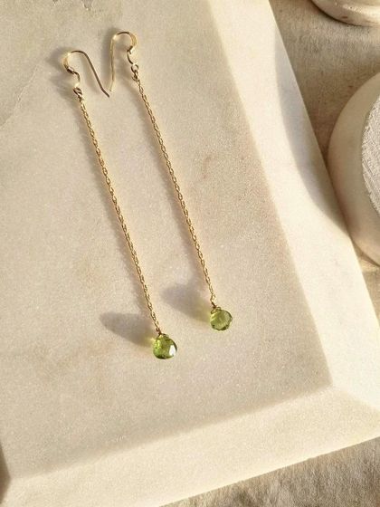 Another view of the 'sū́ra' Peridot heart-shaped drop earrings. I designed them to help sharpen the mind and open it to new levels of awareness.