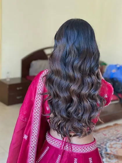 Beautiful, soft waves for the sister of the bride. This is a classic and elegant hairstyle that is perfect for any wedding event.