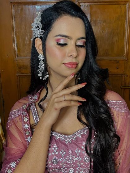 A beautiful pose showcasing the makeup and the perfectly manicured nails.