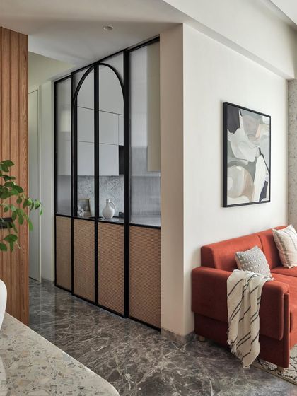 A kitchen masterpiece designed for both style and functionality. The arched sliding doors with fluted glass and cane panels create a beautiful screen, while the serene neutral tones provide a calming ambiance.