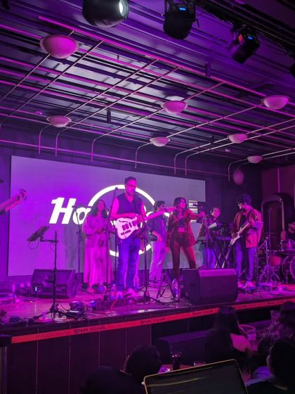 The Moksha All Stars rocking the stage at Hard Rock Cafe. The purple lighting and full band setup create a classic rock show atmosphere that our audiences love.