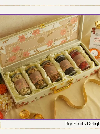 The 'Dry Fruits Delight' hamper. This classic Diwali gift is presented in a beautiful floral suitcase, containing an assortment of premium quality dry fruits in elegant glass jars.