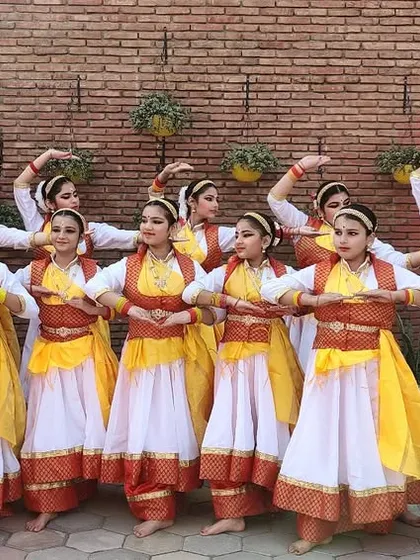 My talented group of dancers in their beautiful white and yellow costumes, ready for a performance. Their poise and unity are a testament to their dedication.