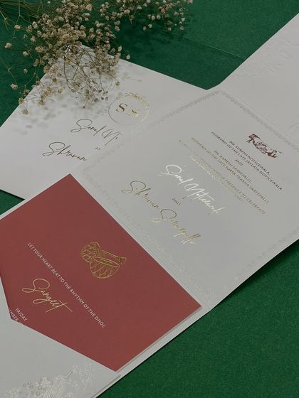 An inside look at our classy and minimal invitation. The suite includes a main card and a contrasting red insert for the Sangeet, all tied together with elegant typography.