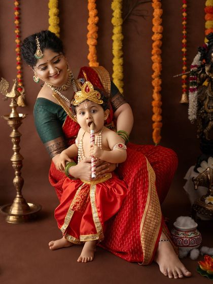A candid moment of the baby playfully chewing on the flute prop, as his mother watches with a smile.