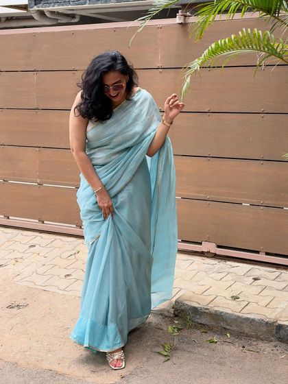 "Saree wala ishq." A candid, happy shot of me in a beautiful light blue saree. This image captures a moment of pure joy and my love for wearing traditional Indian attire.