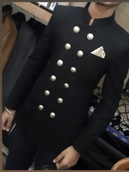 A close-up look at a custom-made black double-breasted Jodhpuri suit. The prominent silver buttons and precise shoulder fit demonstrate my commitment to detailed craftsmanship.