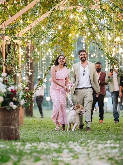 Ameera and Richard making their entrance at the reception with their furry friend. Including pets in the celebration adds a wonderful, personal touch.