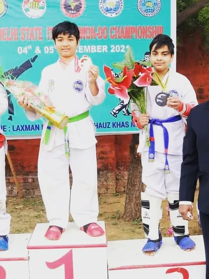 One of my students on the podium after winning a medal at the state championship. Every medal represents hours of practice and dedication in the dojo.