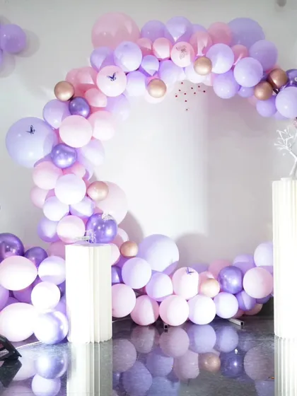 I don't just decorate my private theatre, I can bring the party to your home too. This beautiful circular balloon arch in shades of pink and purple is an example of an indoor home decoration I did for a special event.