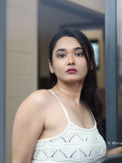 A simple, direct portrait that feels fresh and modern. The clean background and natural pose make it very versatile.