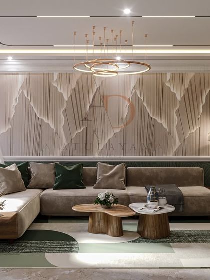 A living room featuring a dramatic, textured wall with a mountain-like design, paired with a neutral sofa and a geometric rug for a modern, organic feel.