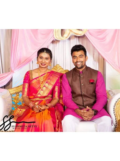 This adorable couple is all smiles. Her makeup features a bright pink lip to match her saree and a natural, glowing base for a fresh and happy engagement look.